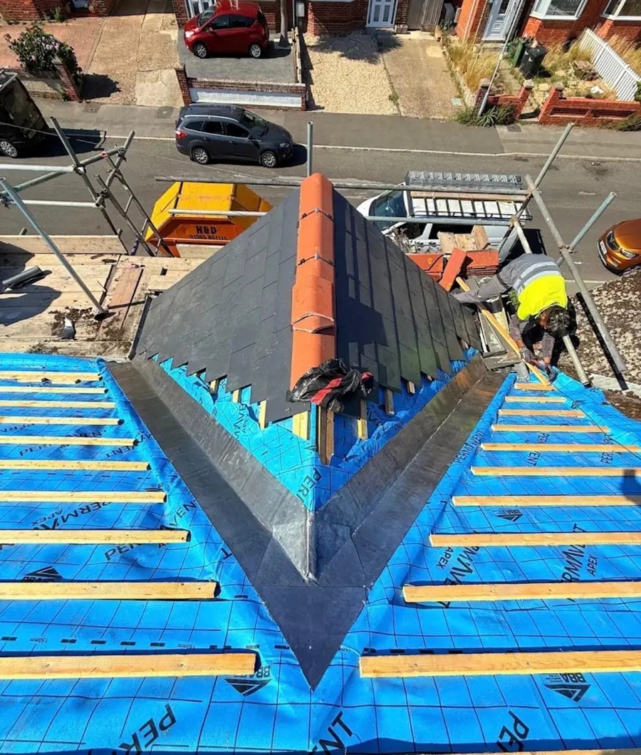 Aerial view of a dormer on a re-roof, membrane and battens on, skip in the street