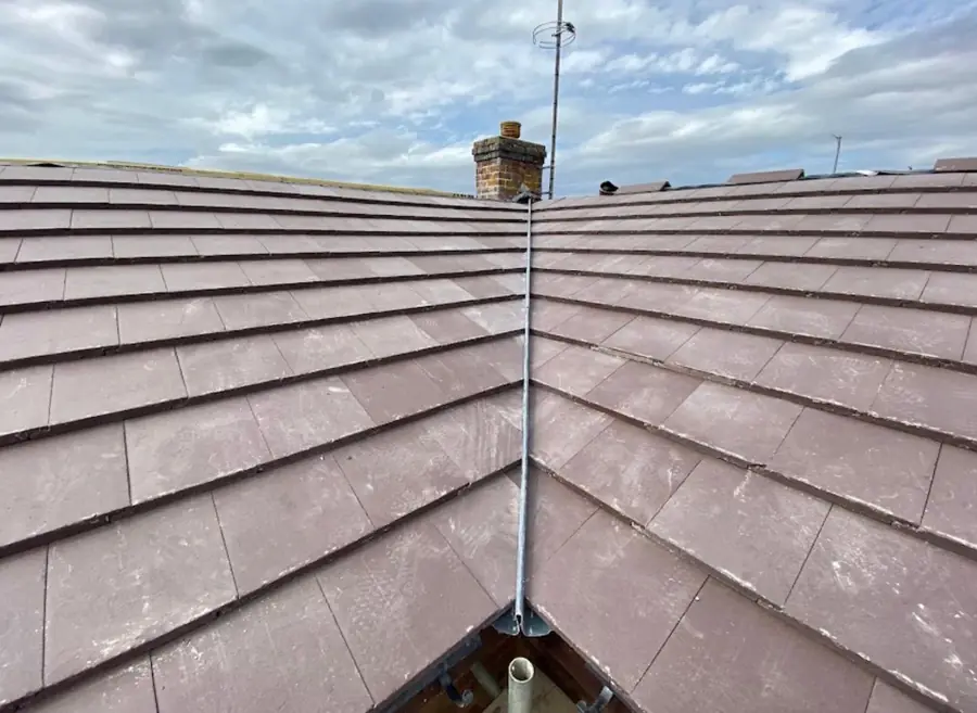 Brown plain tile roof with a new lead valley between two slopes