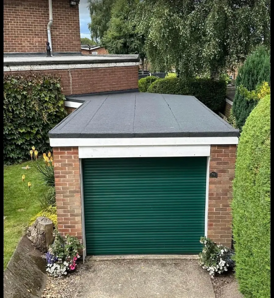 After: the same garage with a new felt flat roof and trims