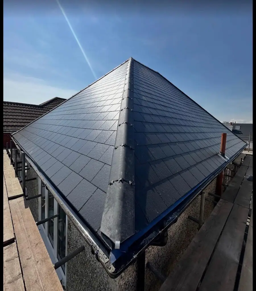 The same bungalow hip roof finished in slate-effect tiles