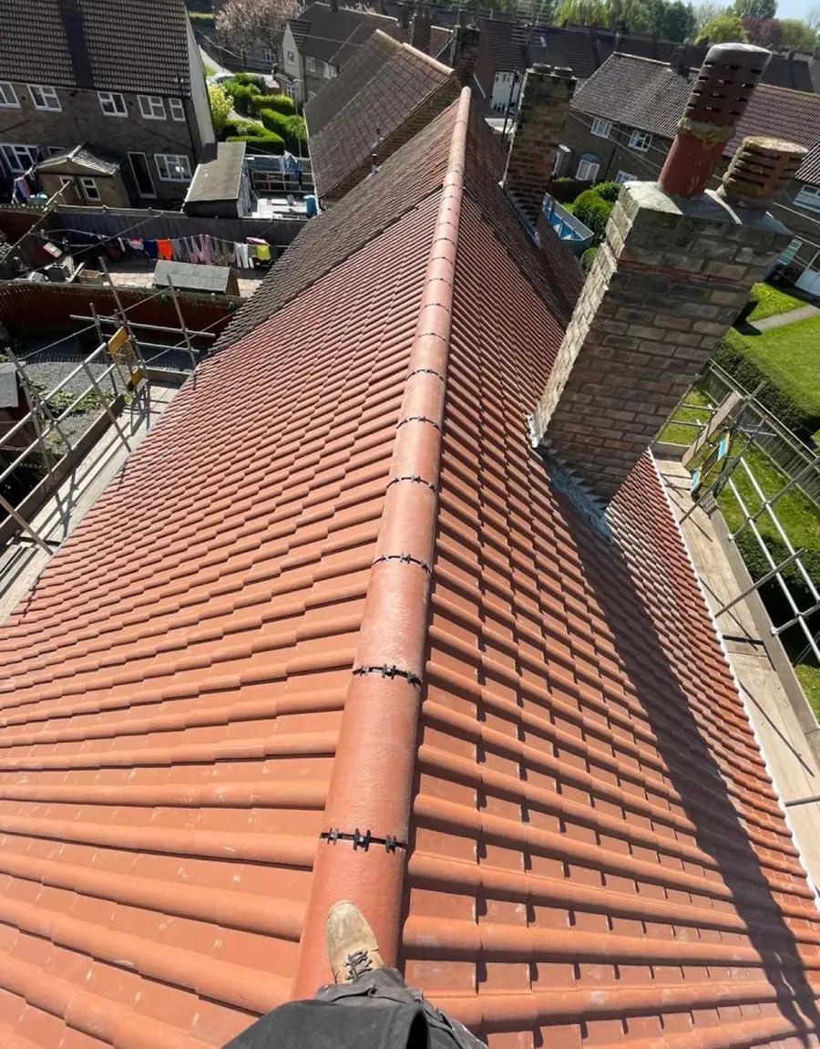 Red interlocking tile re-roof with a brick chimney and new dry ridge